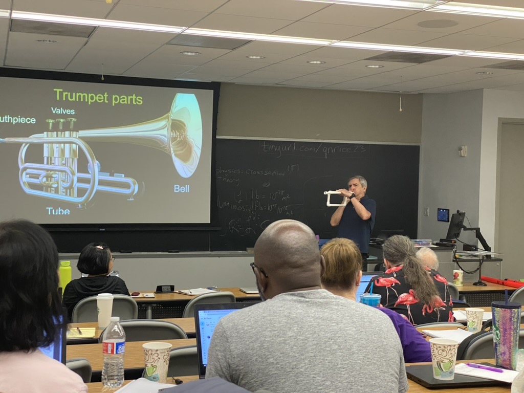 Prof. Toffoletto demonstrates a cheap PVC-based trumpet in his lecture on the Physics of Music